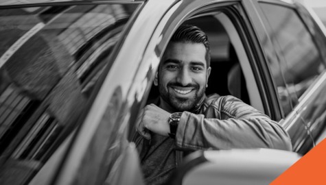 Selling a Used Car in Ontario | Billyard Insurance Group | Man in driver's seat of car smiling