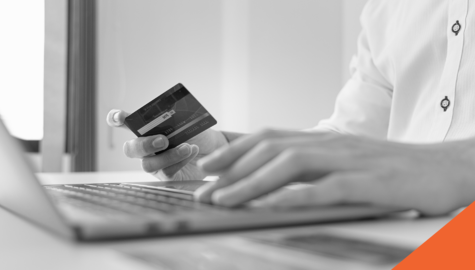 How to Pay Off Credit Card Debt in Canada | man with credit card in hand at computer | Billyard Insurance Group Blog