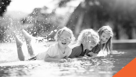 Childlren splashing in pool