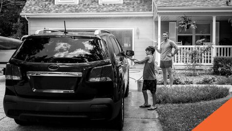 Father and son washing car