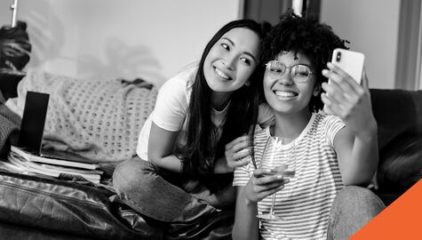 two students taking selfie with wine