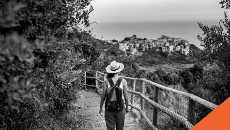 Woman walking across bridge in Italy