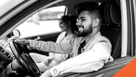 Happy couple driving in car