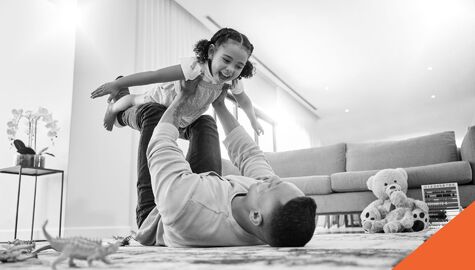 Father and daughter playing in living room