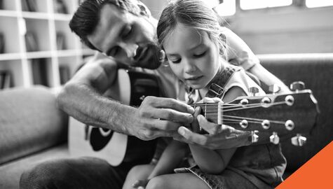 father and daughter playing guitar