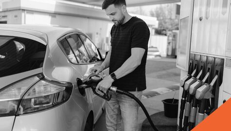 man filling up car at gas tnak