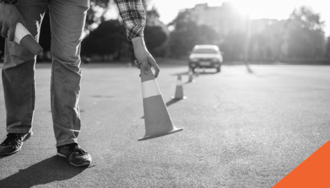 driving school teacher placing cones for practice