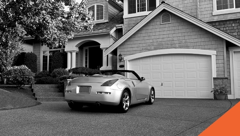 convertible car parked in driveway of beautoful home