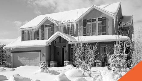 house in winter covered and snow and ice