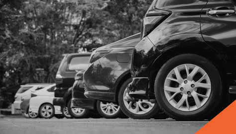 A row of cars parked in a parking lot