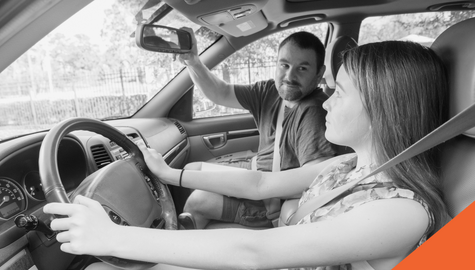 father teaching daughter to drive