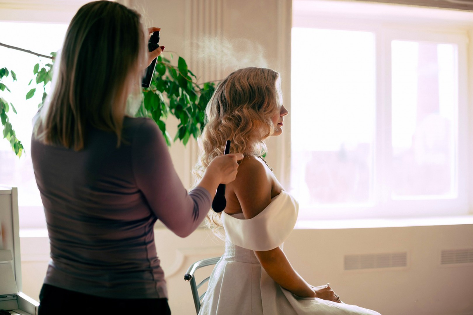 Insurance for Hair Stylists - Hair stylist Spraying Brides Hair